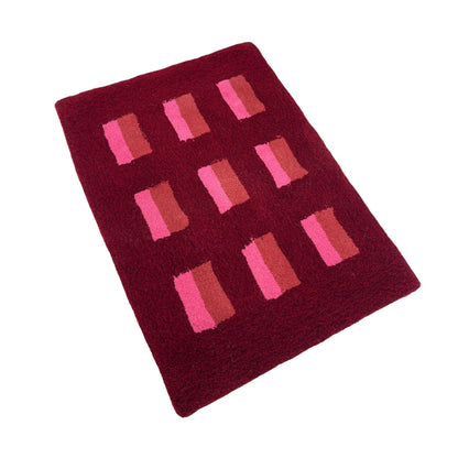 'Mulled' Hand tufted red, pink and burgundy small tufted rug