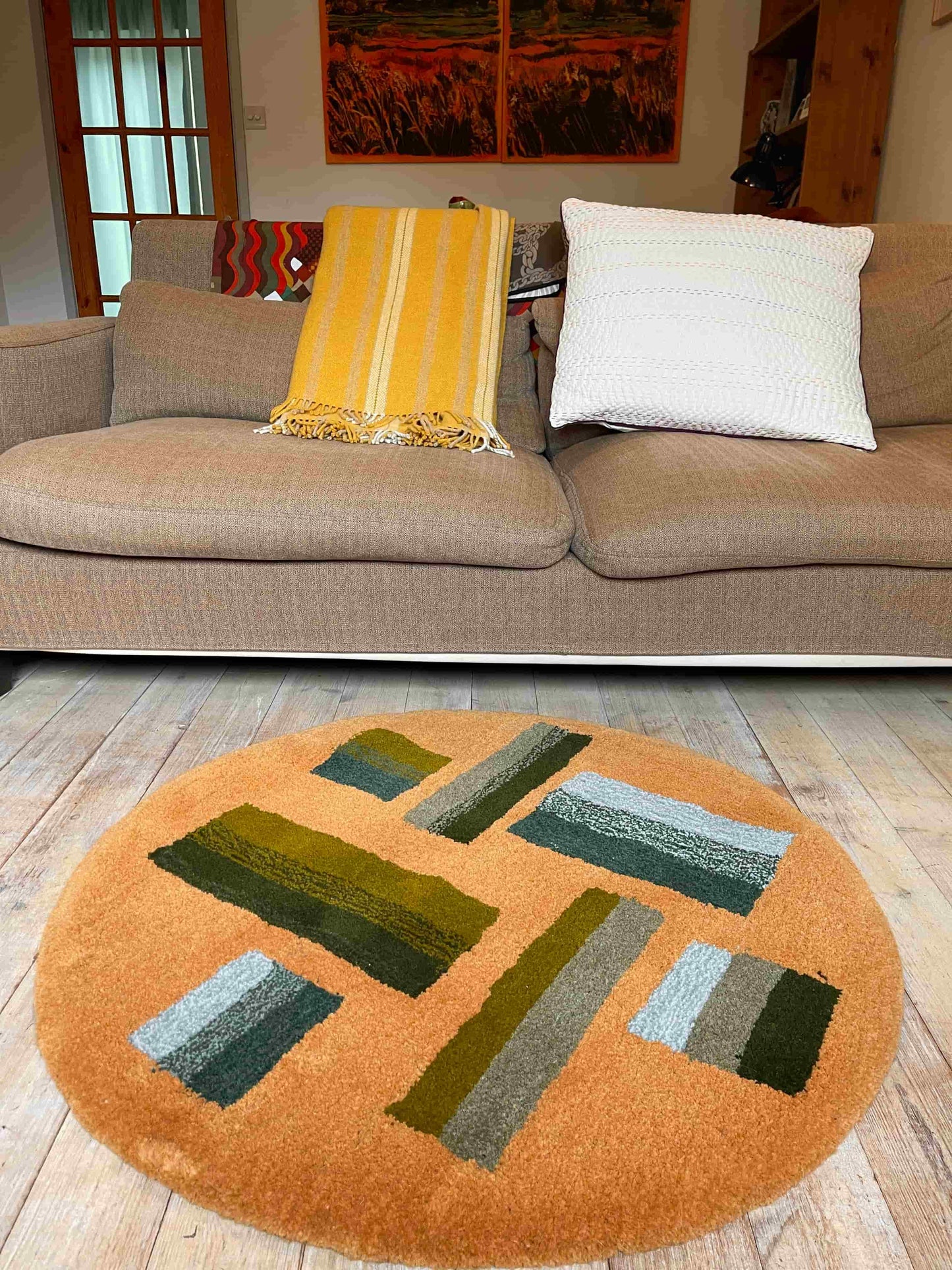 'Hitomi' Hand tufted ochre mustard, dark green and teal circular small tufted rug