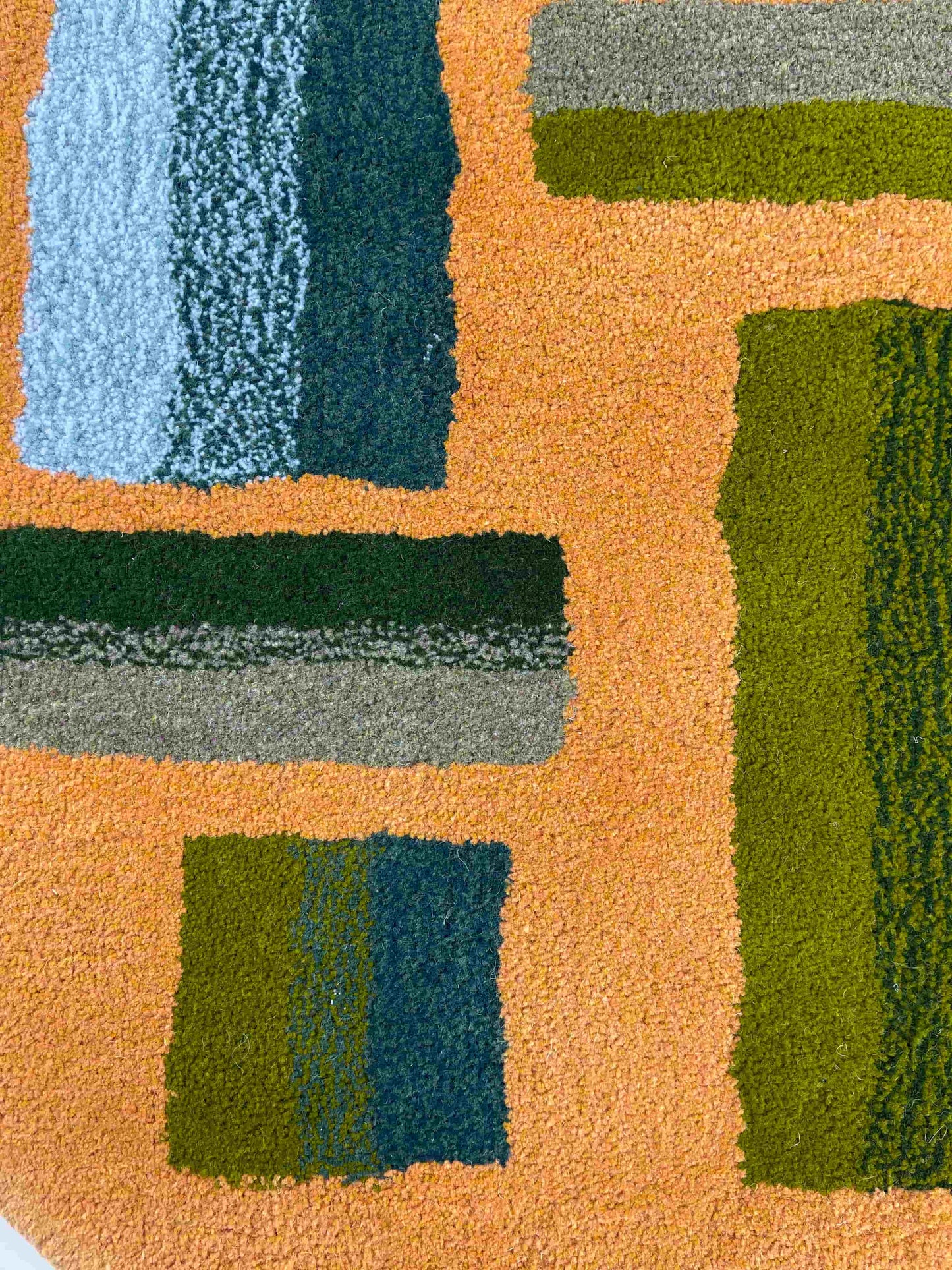 'Hitomi' Hand tufted ochre mustard, dark green and teal circular small tufted rug