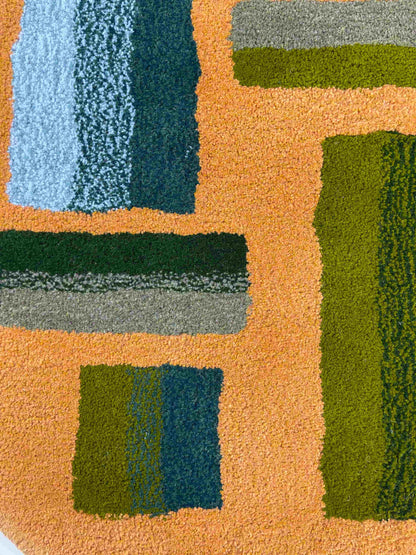 'Hitomi' Hand tufted ochre mustard, dark green and teal circular small tufted rug